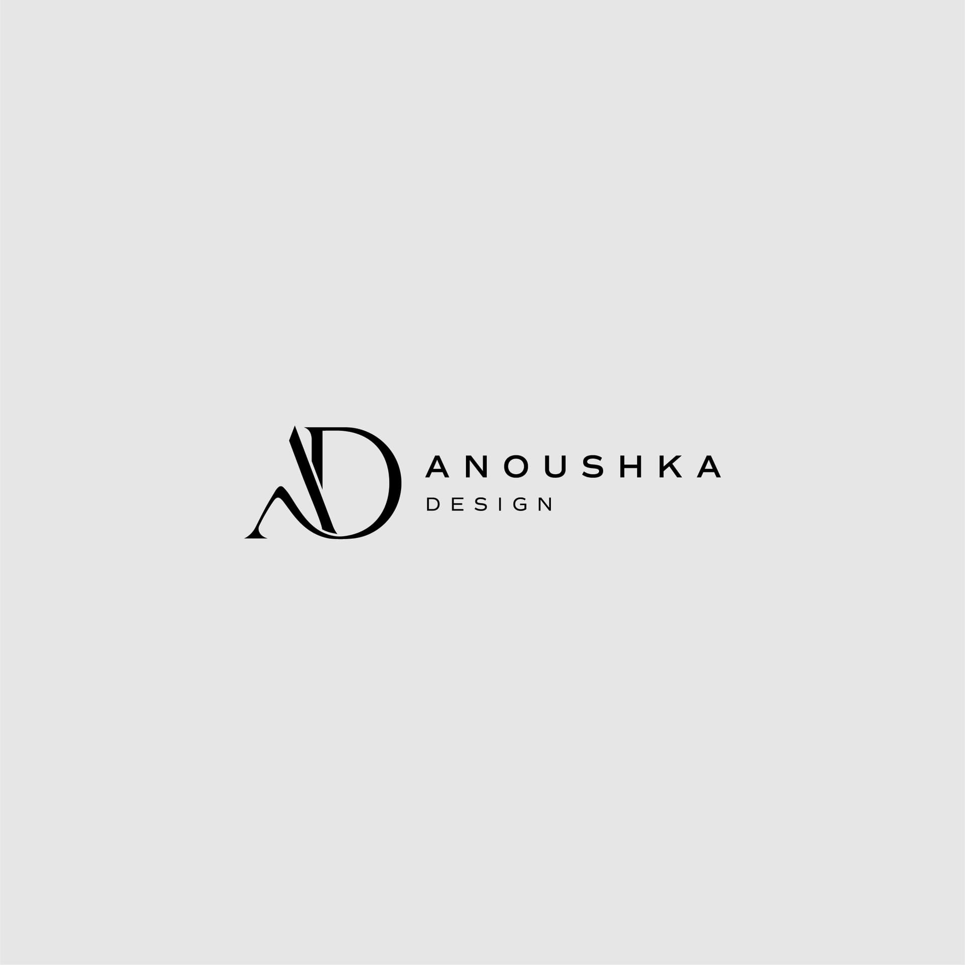 Stylized "AD" logo for Anoushka Design on a light gray background, featuring elegant black typography.