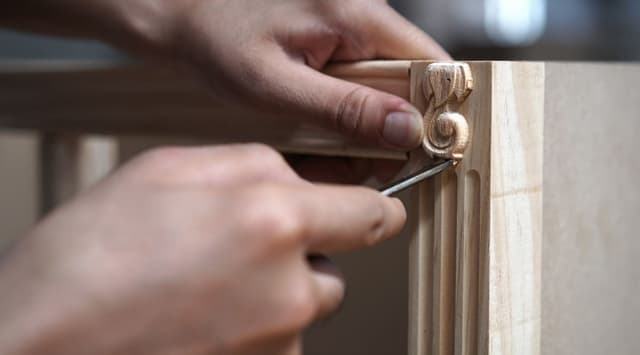 An artisan carving furniture