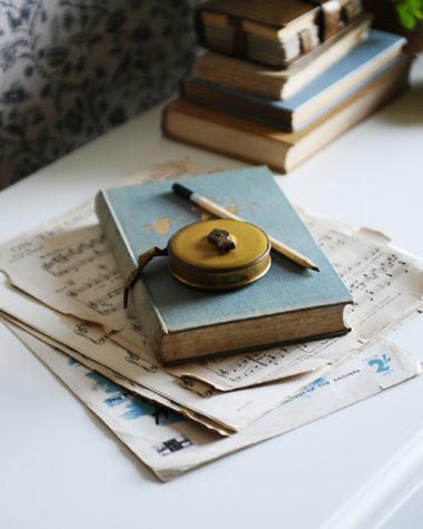 White desk, yellow, lamp, blue book, music paper